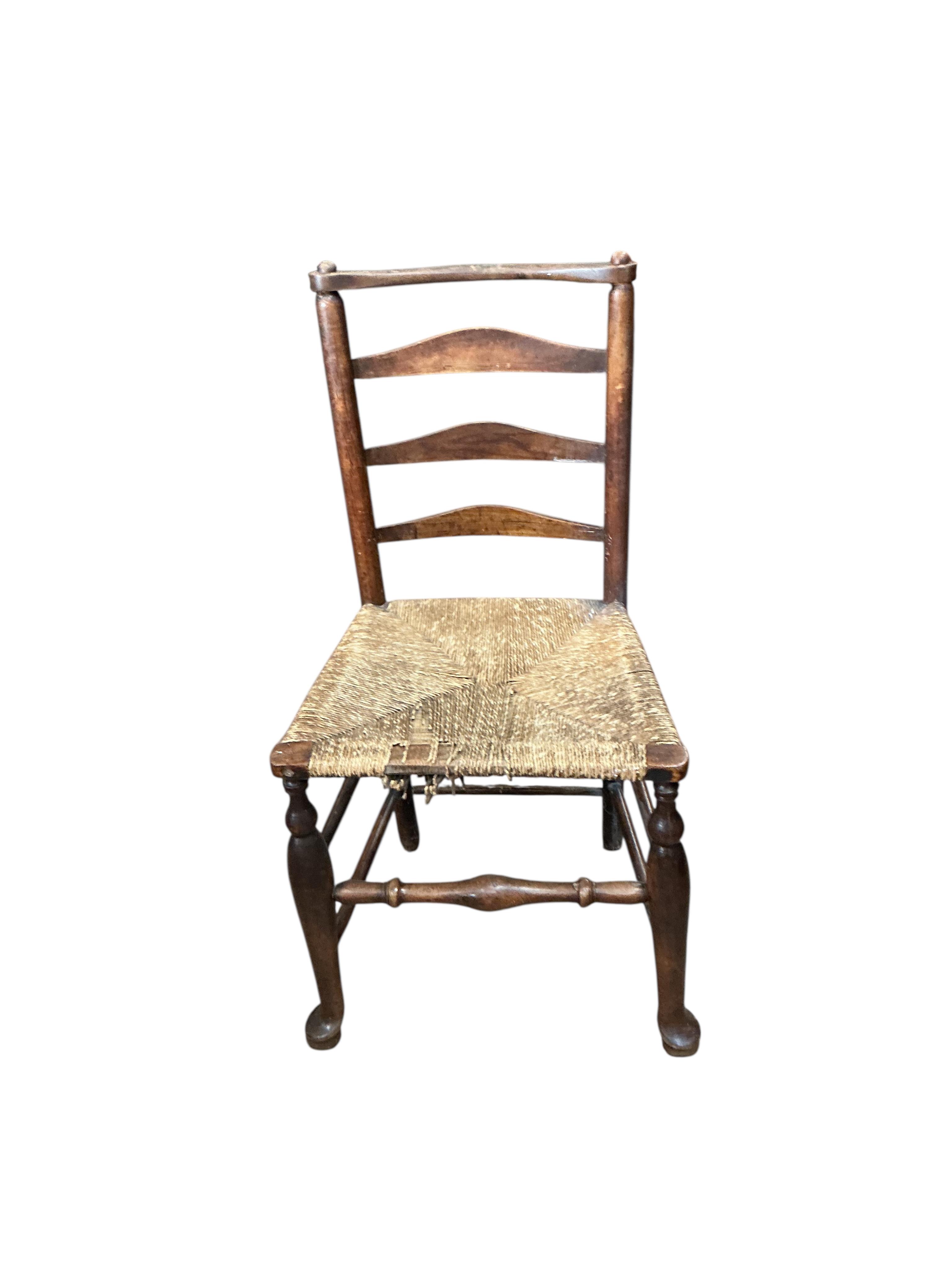 A harlequin set of six 19th century Provincial ladderback dining chairs, one with arms